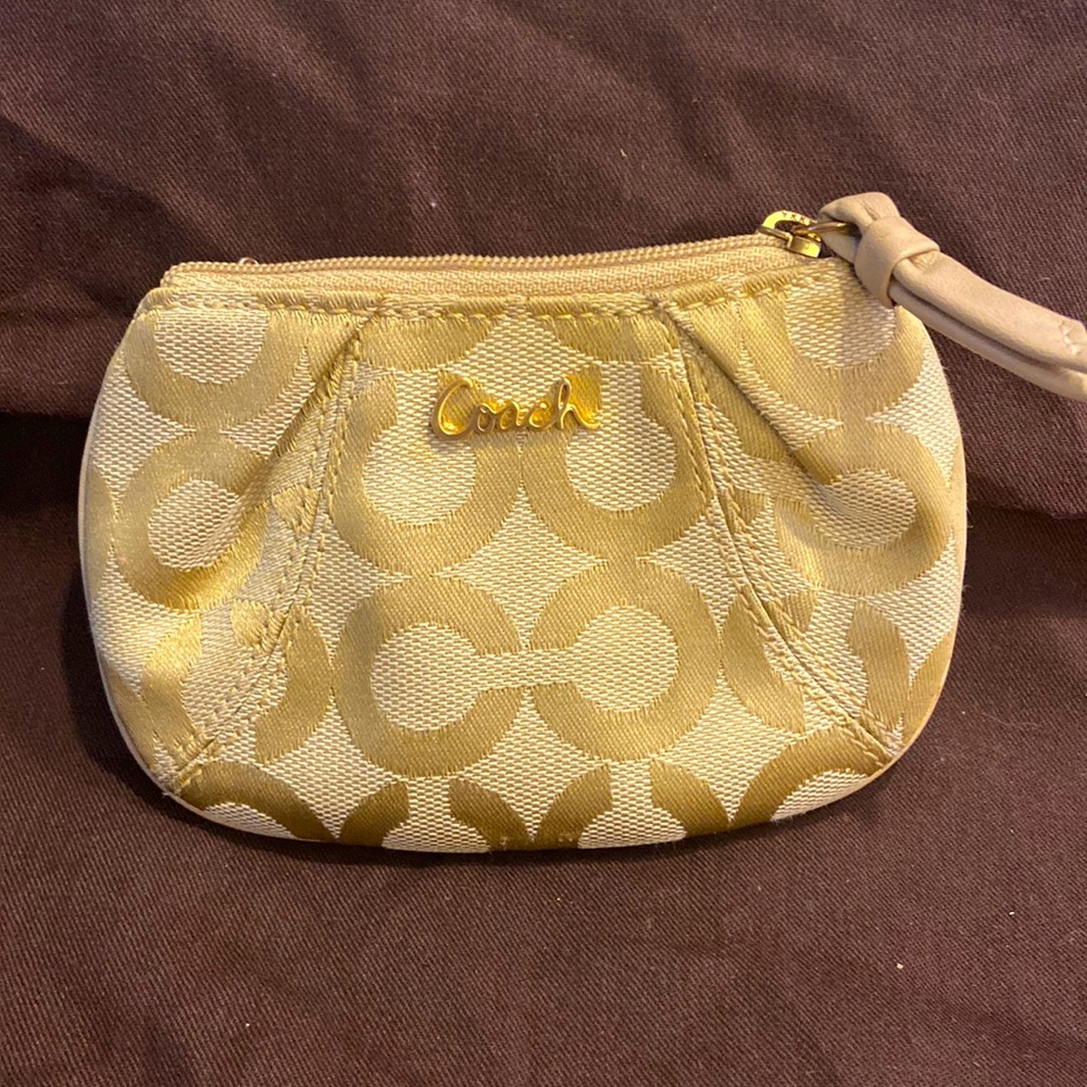 Coach gold signature canvas cosmetics bag.